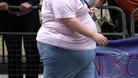 An obese woman walking through central London.