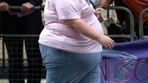 An obese woman walking through central London.