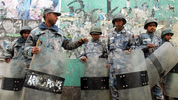 Nepalese policemen take position on a street near the royal palace in Kathmandu in February 2005