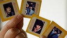 Auctioneer Paul Fairweather holds four colour transparencies of The Beatles taken during their first tour of the USA in 1964.