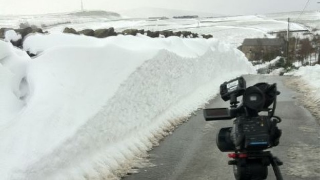 Camera in front of snow drift