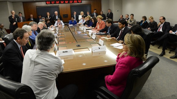 State Secretary Hillary Clinton (in pink) on her first day back at work