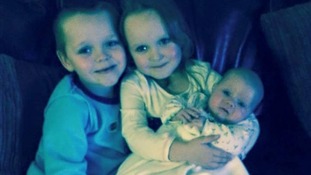 Brandon, Lacie and Lia are seen in a family photograph.