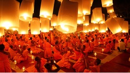 Buddhist monks launch paper lanterns into the sky to pay homage to Lord Buddha