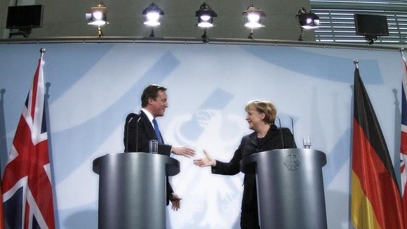 David Cameron shakes hand with German Chancellor Angela Merkel during a news conference