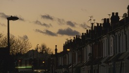 Row of terraced houses set against sky at dusk