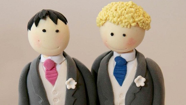 A wedding cake topper for a civil partnership with two men.