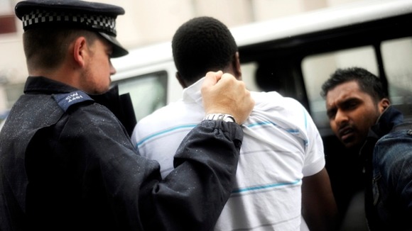 Man being arrested after riots