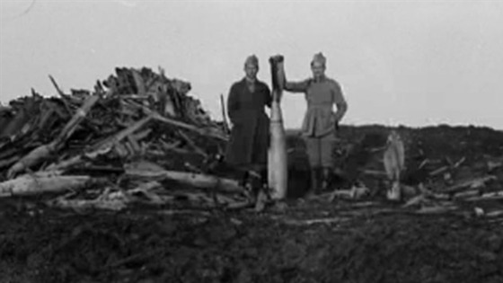 Orlov's favourite image, showing two men posing with a WW1 bomb