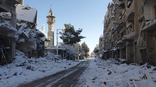 Snow covers buildings that activists say were damaged by missiles from Syrian Air Force planes in Daraya, near Camascus