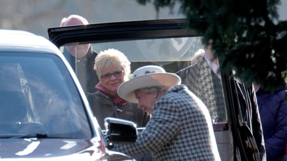 The Queen looks on as her Bentley struggles to start