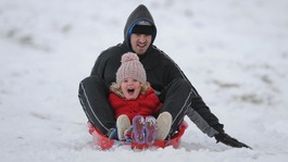 Luke Kent and Darcie-Mae Montgomerie from Leicester sledge at Bradgate Park, Leicestershire