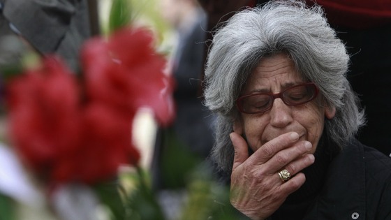 A mourner at a shrine to Greek pensioner Dimitris Christoulas.