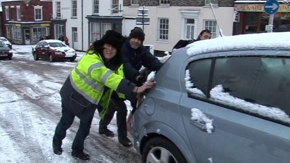 People push a car on Market Avenue