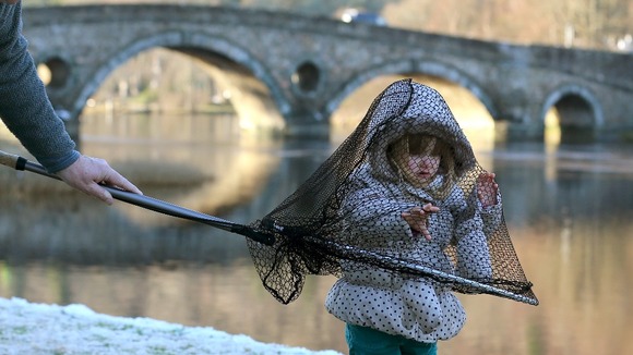 Two year old Kiera Gowan from Pitlochry plays with a fishing landing net at Kenmore on the river Tay