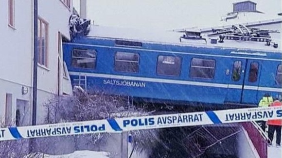 Swedish officials say a cleaner hijacked an empty commuter train for a mile before crashing into an apartment building