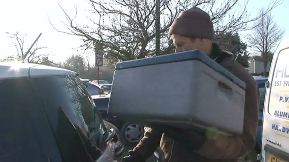 A meals on wheels volunteer delivers a meal