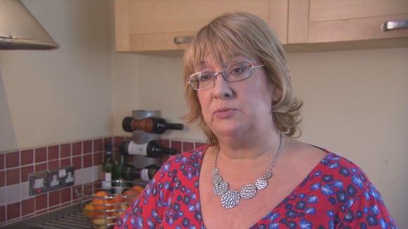 Middle aged lady head and shoulders in kitchen