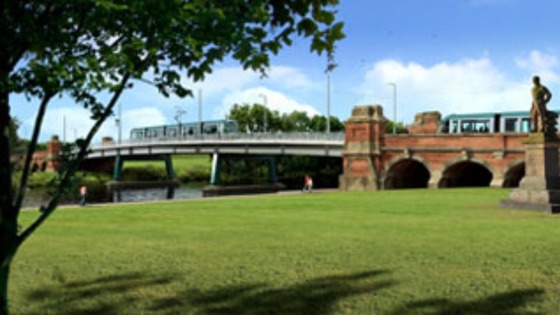 Trams passing over the widened Grade II listed Wilford Toll Bridge.