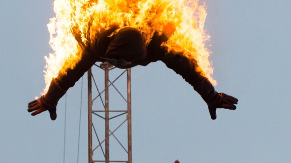 The diver makes the plunge and dives into the water tank.
