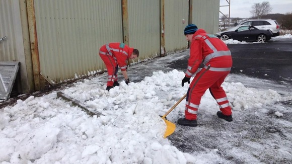Paramedics clearing snow