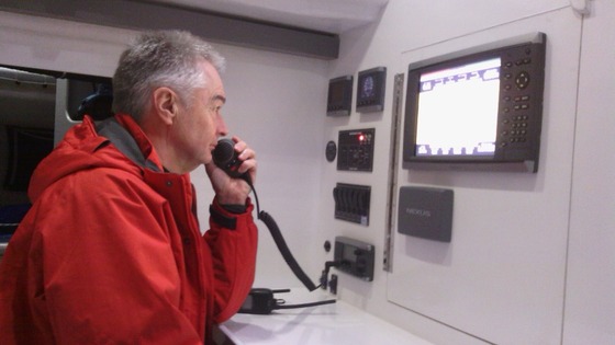 One of the crew tests out the radio before the grand voyage