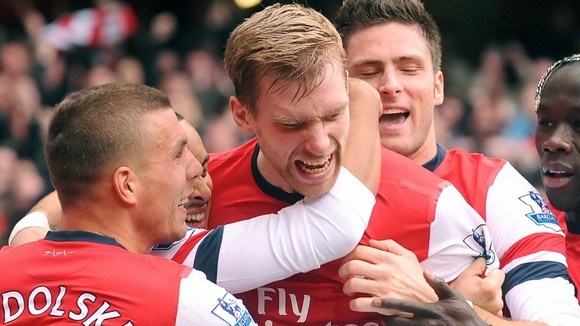 The German defender being mobbed after scoring for the Gunners