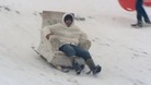 A man speeds down a Norfolk hill in his toboggan armchair.