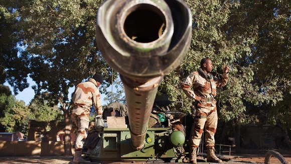French soldiers pictured today in Niono with military weapons.
