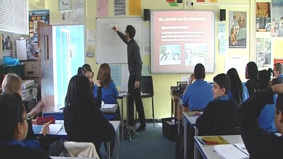 A teacher gives school children a lesson