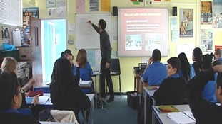 A teacher gives school children a lesson