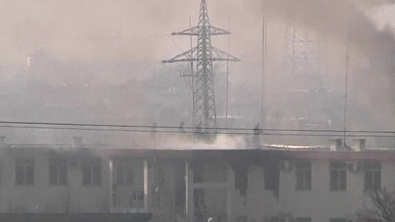 Afghan security forces run on the roof of the Kabul traffic police headquarters 