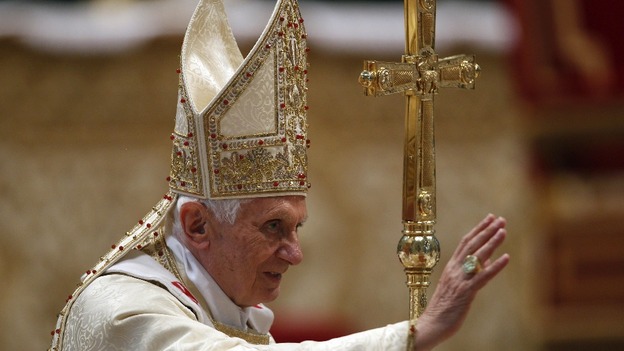 Pope Benedict XVI blesses faithful at the end of a Chrism Mass in St. Peter's Basilica at the Vatican