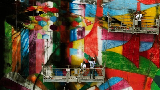 Brazilian graffiti artist Kobra puts the final touches to his mural