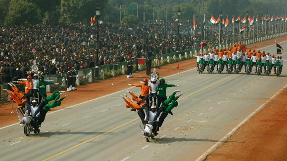Indian soldiers perform a dare-devil show on their motorcycles