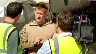 Prince Harry in November 2012 giving a TV interview by his helicopter in Camp Bastion