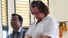 Lindsay Sandiford, with her translator, listens to the judge during a trial in Denpasar in Bali