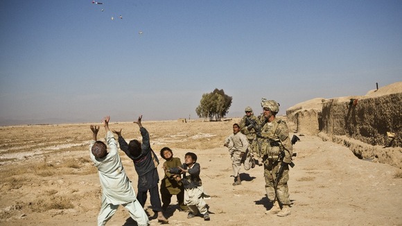 U.S. soldiers throw sweets to children in Afghanistan