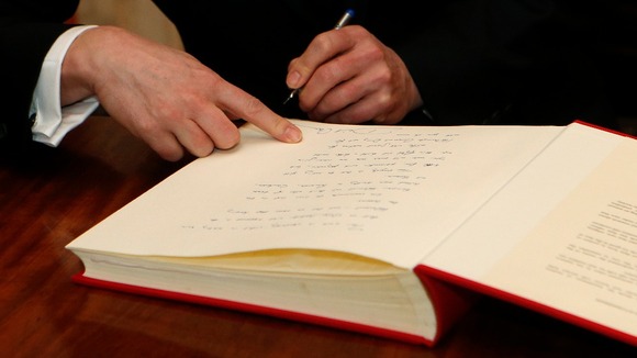 David Cameron signs the Book of Commitment ahead of Holocaust Memorial Day