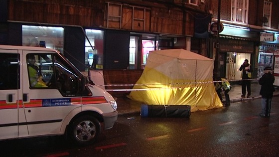 Police remain on the scene in Camden, north London where a man was killed after a sign fell from a store