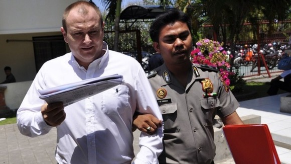 Paul Beales escorted by a policeman as he arrived for a court appearance
