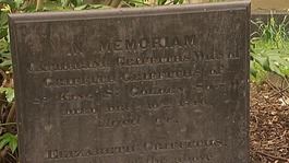 A gravestone in the park.