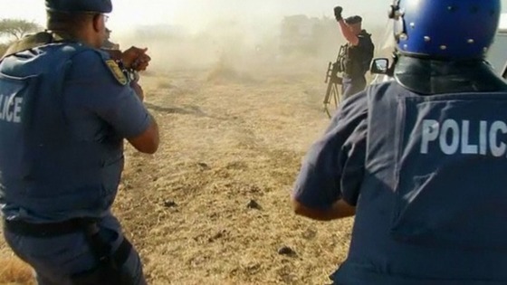 Police fire at striking miners outside a South African mine owned by Lonmin's of London 