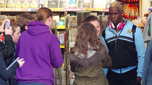 Mario Balotelli with fans at Stockport Train Station.