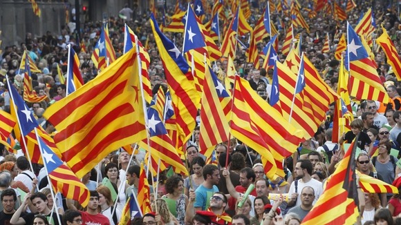 Marchers wave Catalonian nationalist flags during a celebration in Barcelona in September 2012