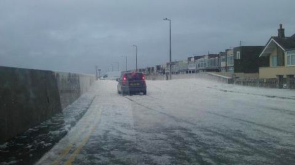 The foam spilling over the sea wall at Cleveleys.