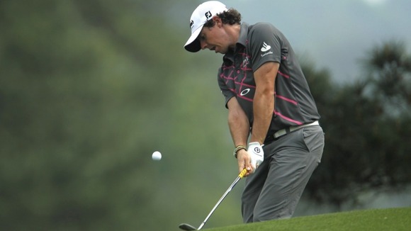 chips to the eighth green during a practice round for the 2012 Masters