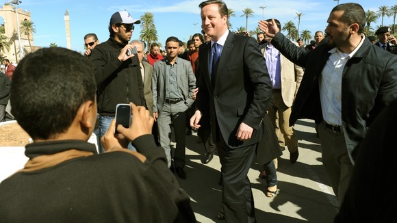 David Cameron walks through Martyrs Square in Tripoli