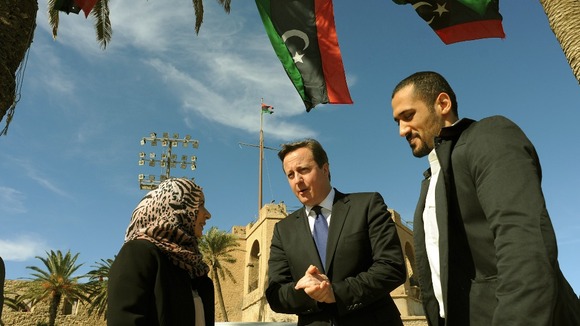 David Cameron takes a walk through Martyrs Square in Tripoli