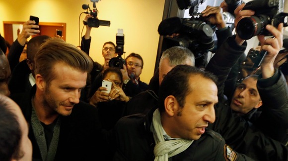 David Beckham surrounded by bodyguards at the Pitie-Salpetriere hospital
